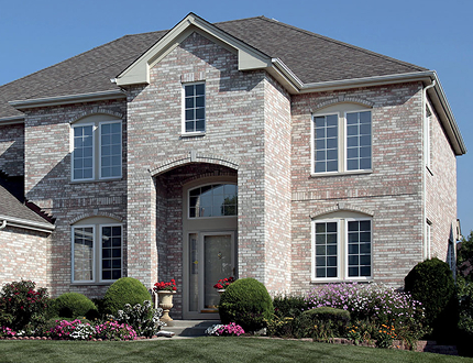 two story gray brick home with newly installed Finestra Windows